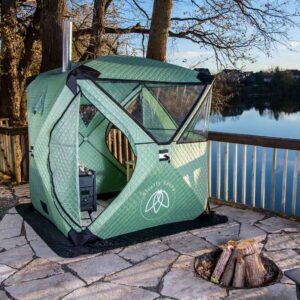 Firefly Spark tent on stone covered ground setup by a fire pit.